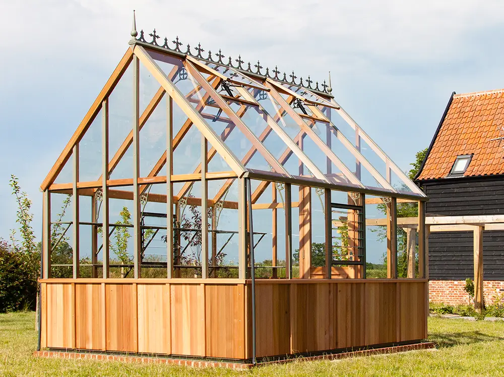 Back of the Alton Cheltenham Greenhouse on a sunny day showing the variation in the wood