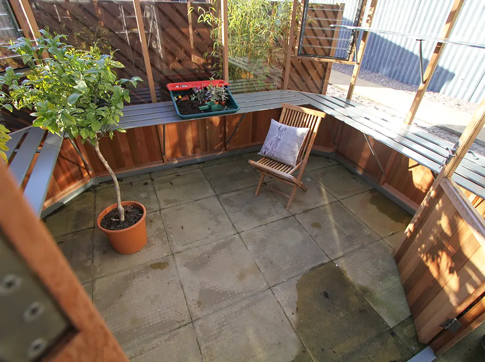 Interior view of the Alton Octagonal Greenhouse with the U-shaped shelving along the walls