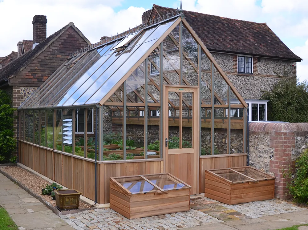 Frontal view of a Alton Westminster Greenhouse with the varying cedar panels