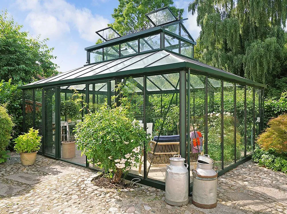Janssens Cathedral Glass Greenhouse in Green in a backyard