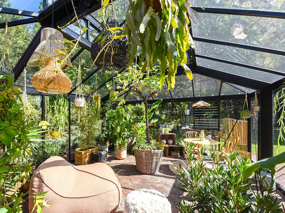 Interior of the spacious Janssens Cathedral Glass Greenhouse with plants and seating