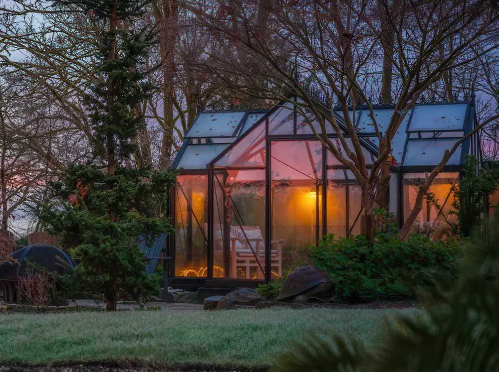 Night time shot of the Janssens Junior Victorian Orangerie in a backyard with lights on