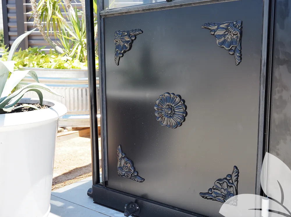 Close-up of the decorative panel of the Janssens Retro Victorian Greenhouse