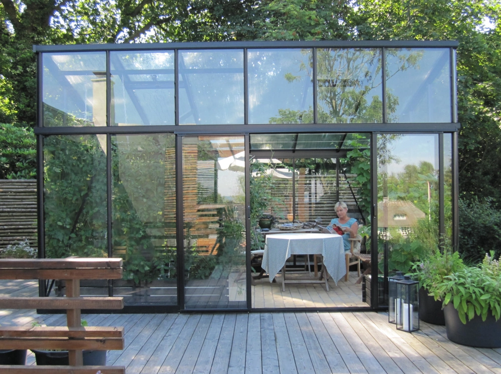 Front exterior view of a Janssens Modern Greenhouse on a treated lumber foundation.
