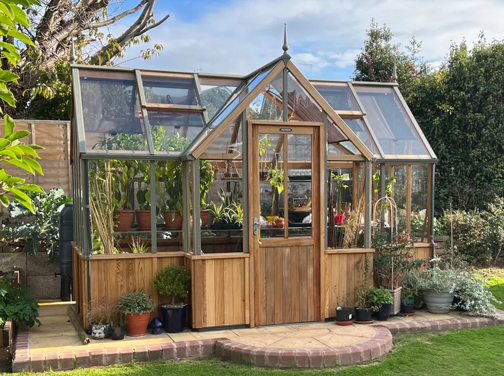 Front of Alton Durham Orangerie built from natural Cedar wood in a backyard setting