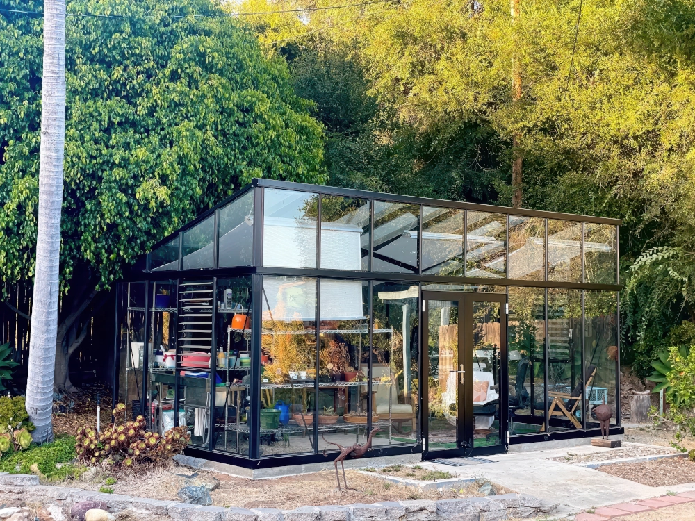 Janssens Modern greenhouse in backyard. 