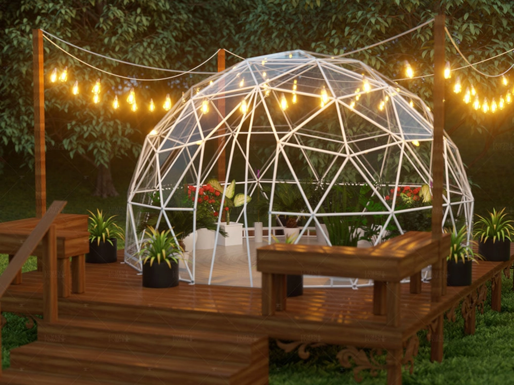 Exterior of Geodesic greenhouse surrounded by outdoor hanging lights at dusk.
