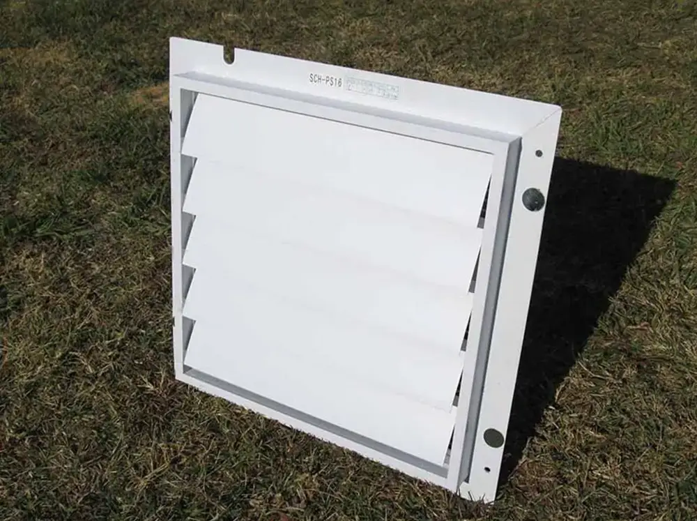 Outer side of the RSI Greenhouse Exhaust Fan System sitting on a lawn