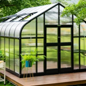 Frontal view of the whole Vego Pacific Greenhouse greenhouse with its curved roof and black framing