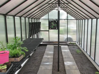 MONT Foldable Work Station Kit installed in MONT Greenhouse with half it folded up and the other side with some plants