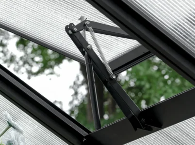 Interior view of a Vego Auto Vent Openers installed on a roof vent - open position
