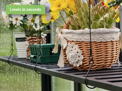 Close-up of the front of the Vego Foldable Shelf with hooks leveling it - text says: Levels in seconds