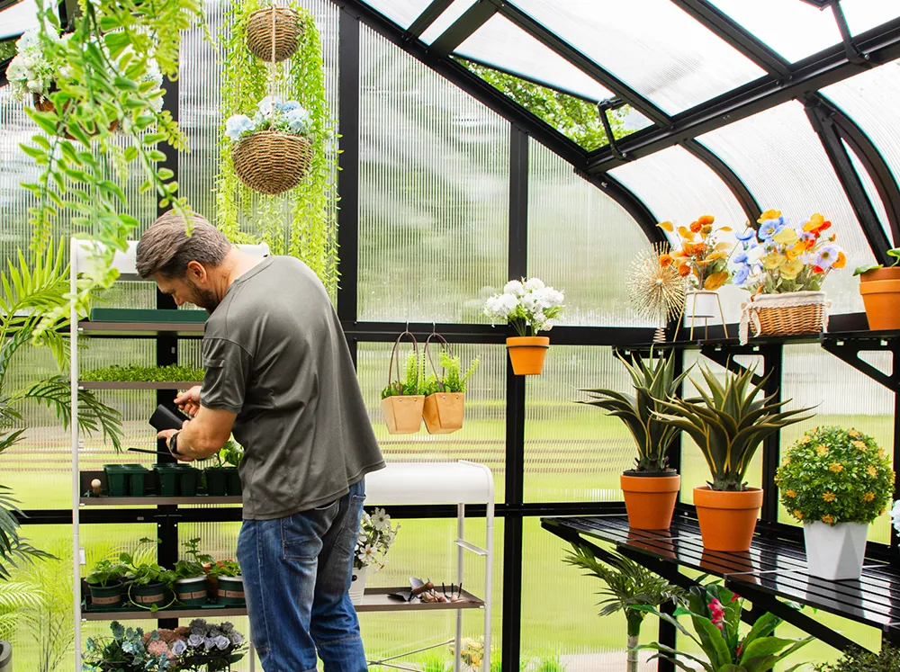 Interior shot of the Vego Grand Pacific Greenhouse with a man gardening
