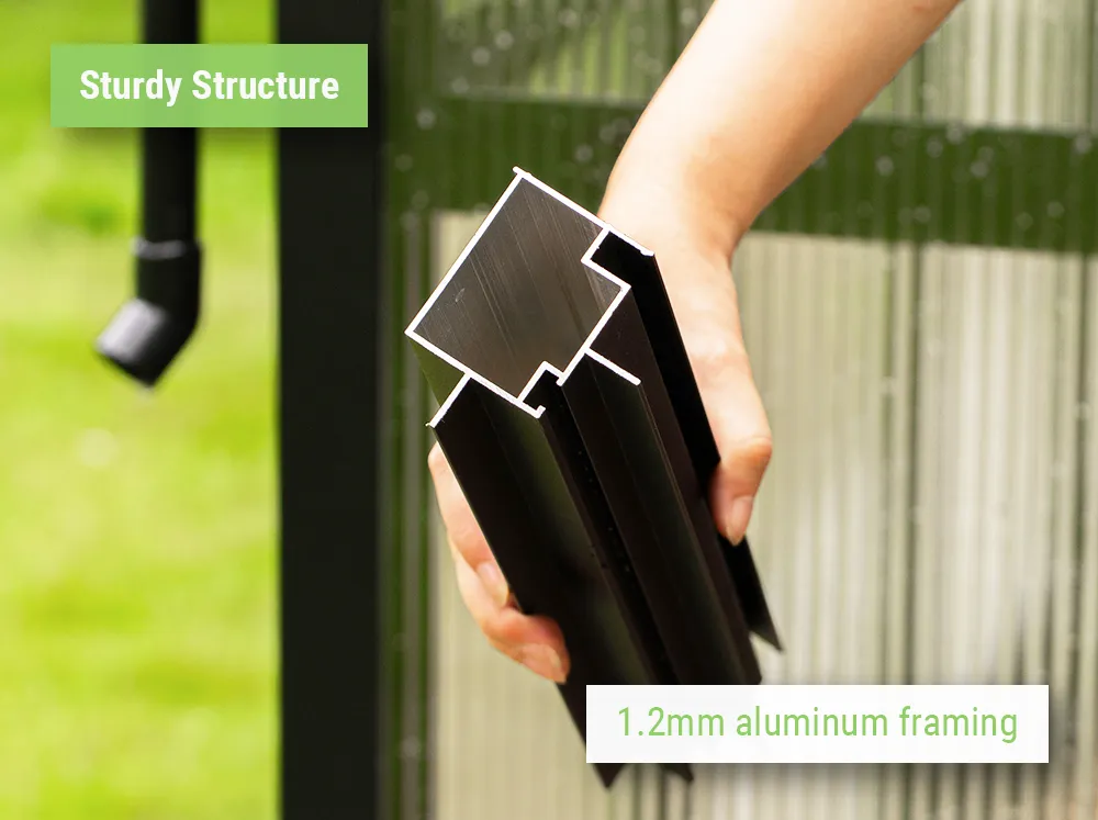 Person holding Vego Victorian Greenhouse in a hand showing how sturdy the framing is