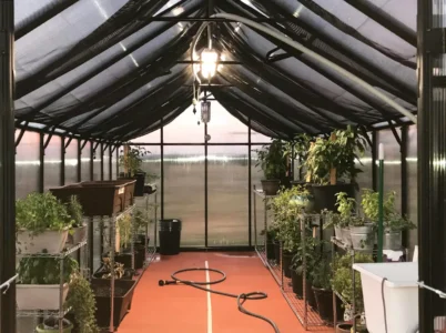 MONT Internal Shade Cloth installed in a MONT greenhouse with a light and watering system