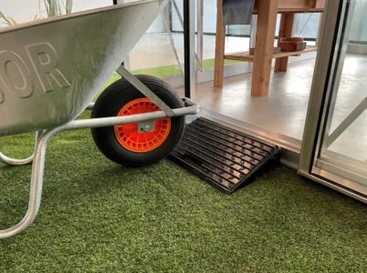 Wheelbarrow moving into greenhouse with help of the Wheelbarrow Access Ramp
