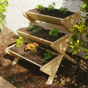 Eden Waterfall Garden Table with plants inside standing along a wall