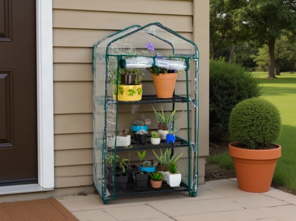 3-tier Genesis Portable Rolling Mini Greenhouse with clear cover on a patio