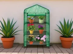 3-tier Genesis Portable Rolling Mini Greenhouse with opaque cover on a patio