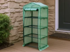 4-tier Genesis Portable Rolling Mini Greenhouse with opaque cover on a patio