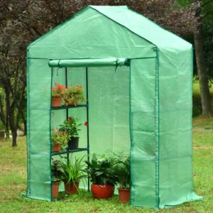 Genesis Portable Walk In Greenhouse with plants inside, rolled up door