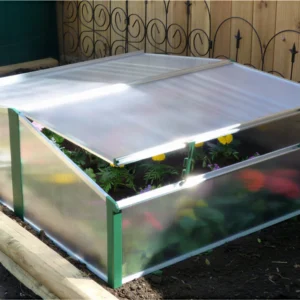 Juwel Easy-Fix Double Cold Frame on a garden bed with flowers inside
