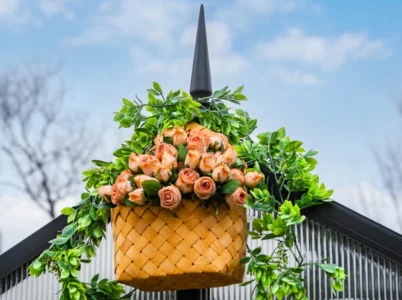 Basket with flowers hanging from the Vego Decorative Greenhouse Finials on a Vego Greenhouse
