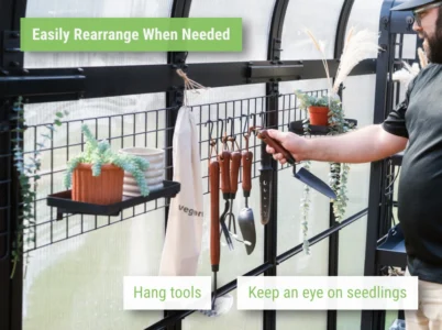 Person hanging trowel on Vego Greenhouse Hanging Grid System