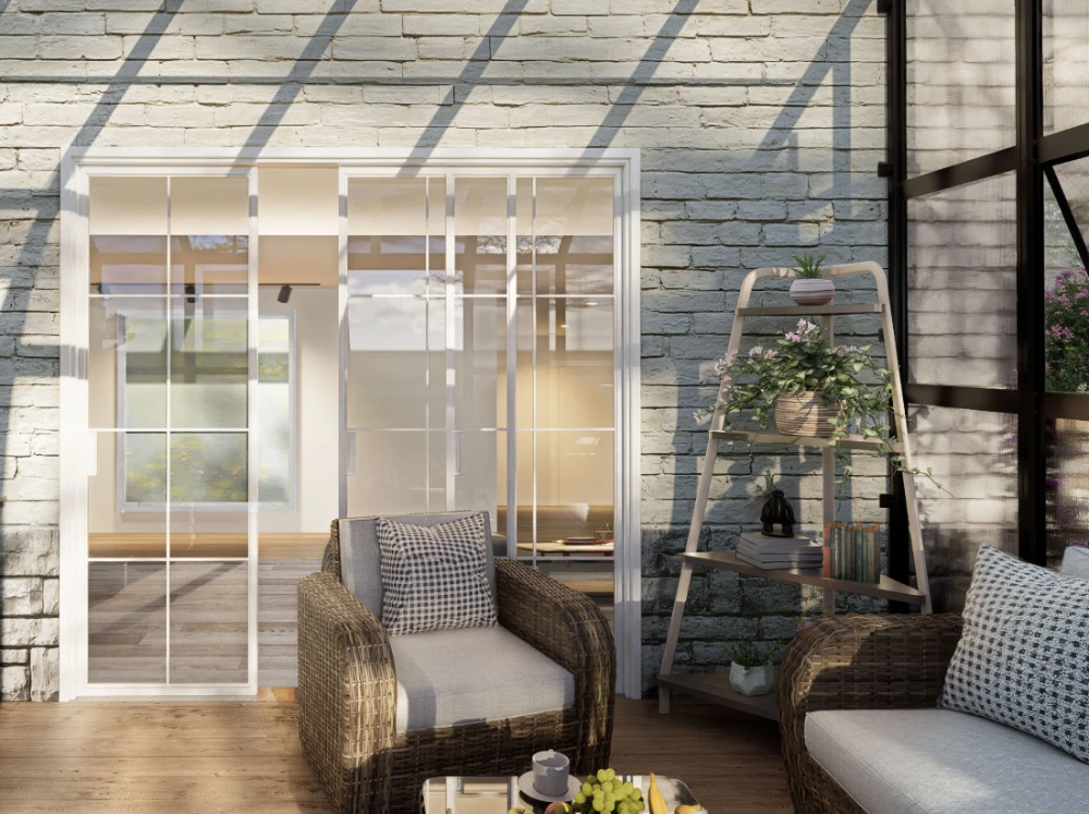Interior of the Vego Grand Lean-To Greenhouse showing a patio door to the house and a seating area right by the door
