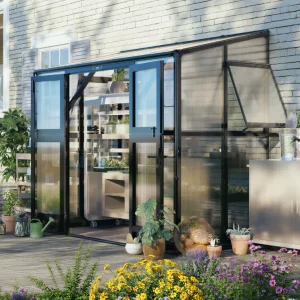Vego Lean-To S Greenhouse installed along a house wall with the patio in the background