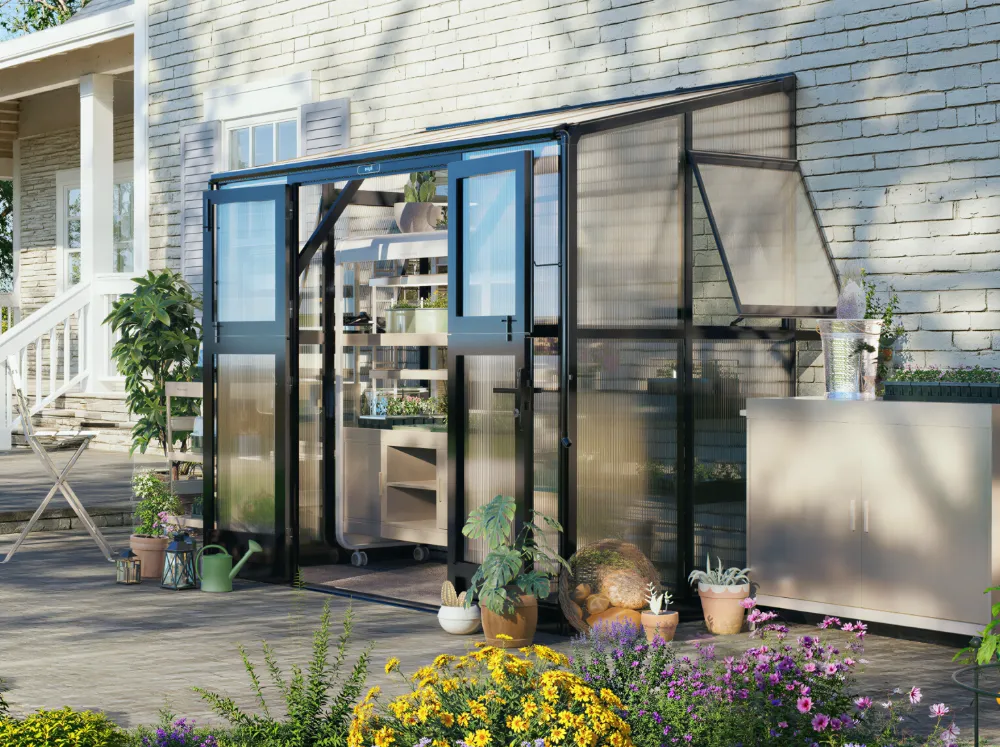 Vego Lean-To S Greenhouse installed along a house wall with the patio in the background
